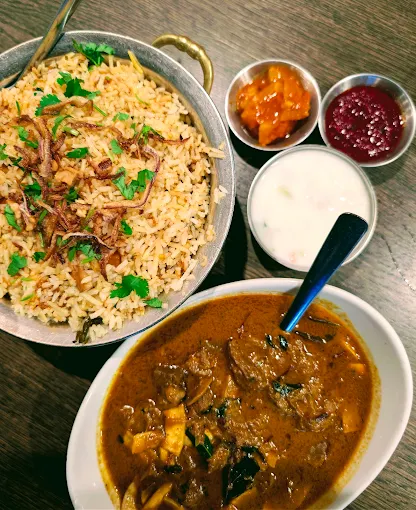 Biryani thali with meat curry, raita and pickle at Kerala Restaurant Edmonton