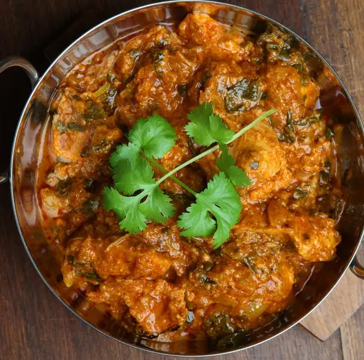 Kerala-style chicken masala in a copper kadai at Kerala Restaurant Edmonton
