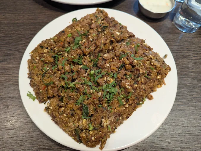 Kothu parotta with chopped parotta, egg and meat at Kerala Restaurant Edmonton